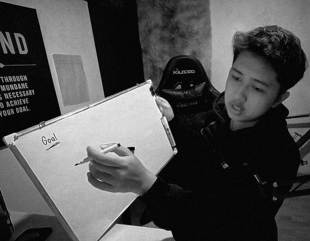 The owner of Guanzon Media writing on a white board