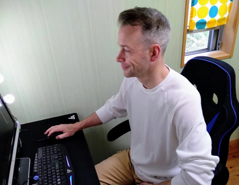 man teaching online student