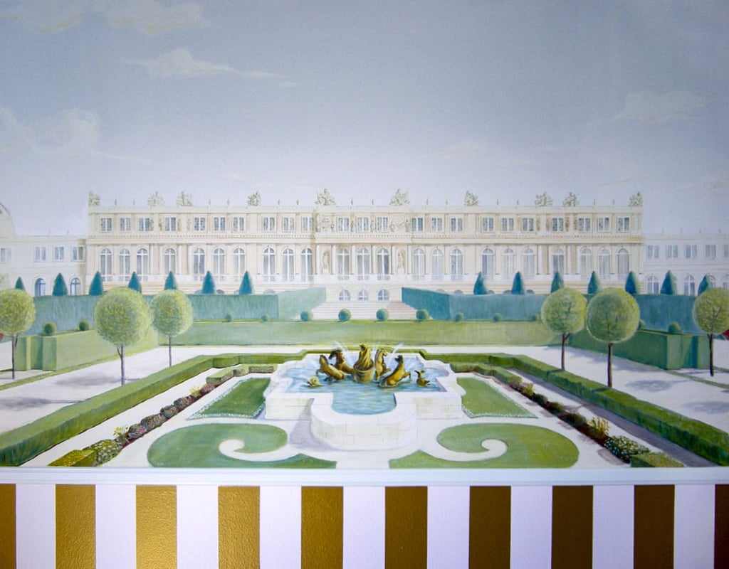 Kid's mural of Versailles, manicured gardens and a pink and gold striped dado.
