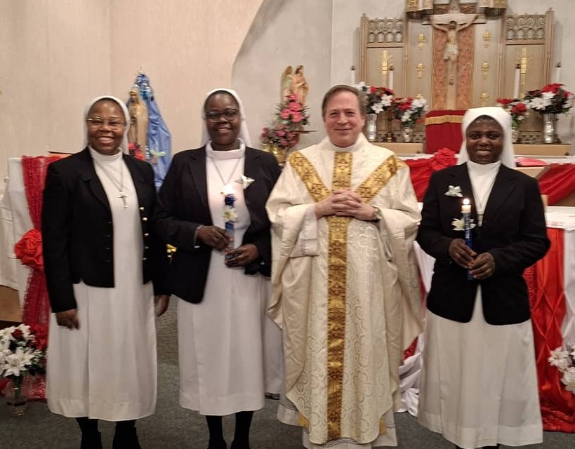 Catholic sisters posing with clergy during Sister's Day of Renewal of Vows