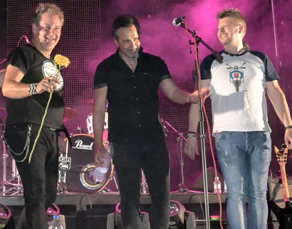 a group of men standing on a stage