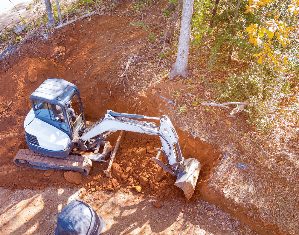 bobcat excavator digging dirt against side hill