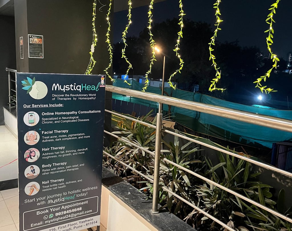 A clear sign positioned on a building's balcony, visible to those walking by, conveying important information