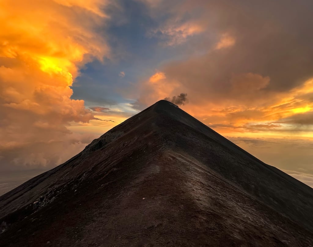 a mountain top with a mountain in the background