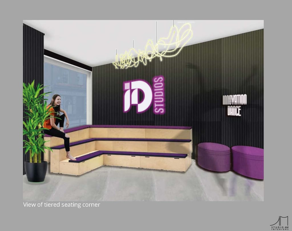 a woman sitting on a couch in a waiting area. stadium bench seats