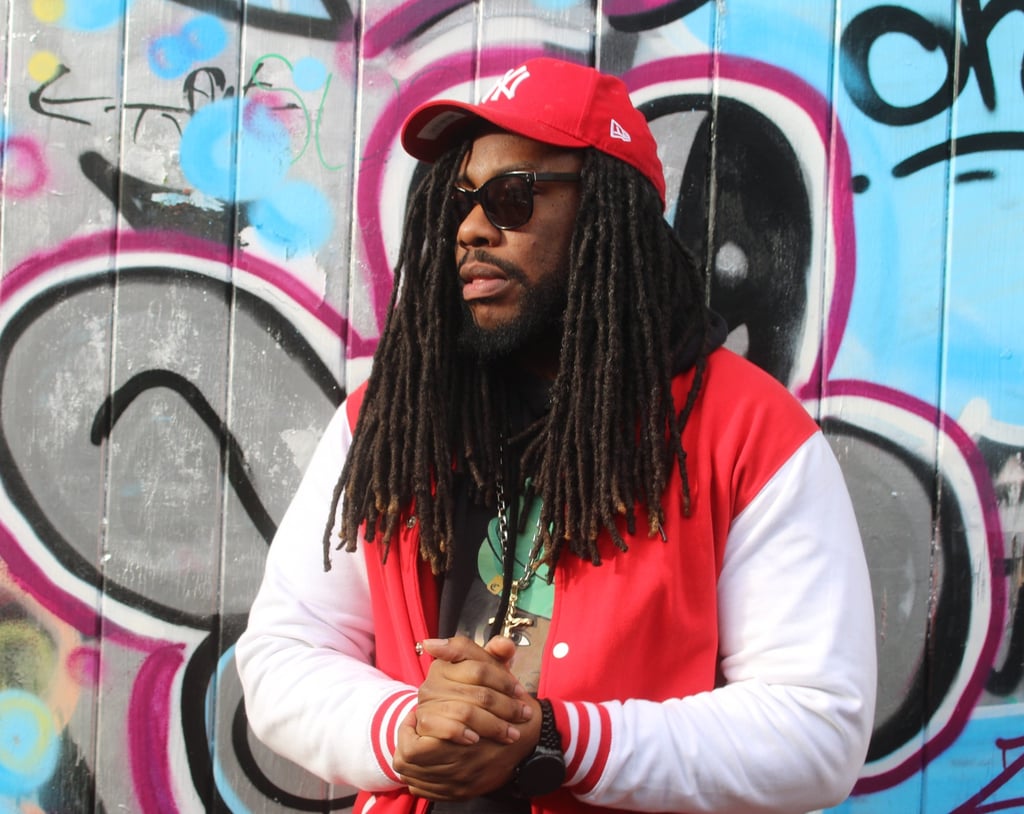 a man with dreadlocks and a red jacket