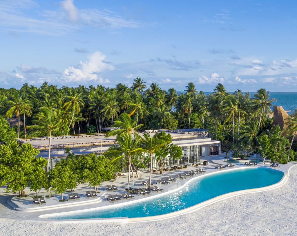 a large pool with a swimming pool and a view of the ocean, St Regis Maldives