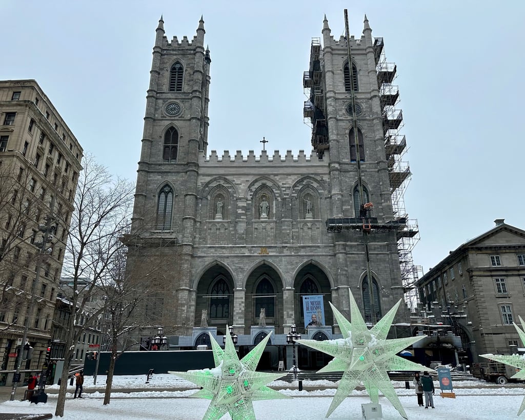 Basilique Notre-Dame de Montréal in the winter with large star statues in front of the towers