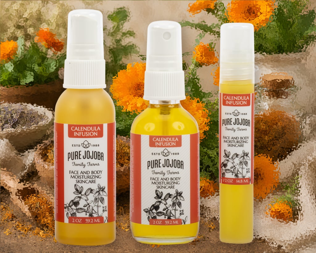 Pure jojoba moisturizing skincare bottles with calendula infusion on a floral background.