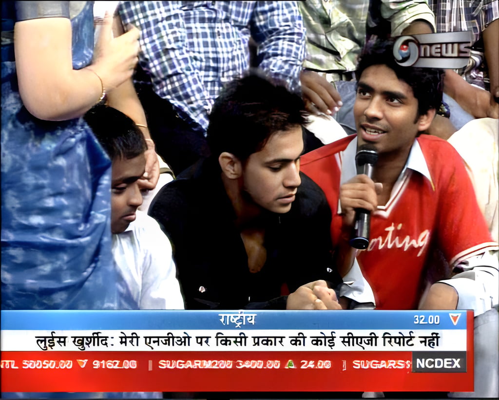 a man in a red shirt is holding a microphone
