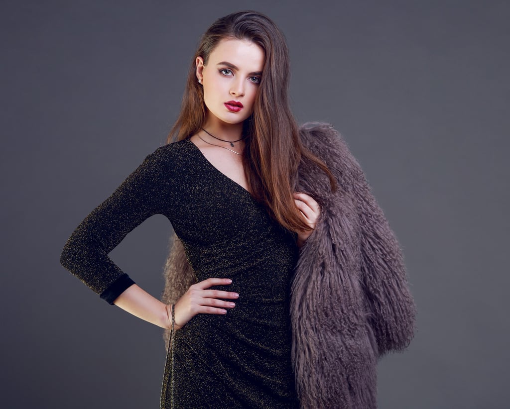 model wearing black dress with fur coat