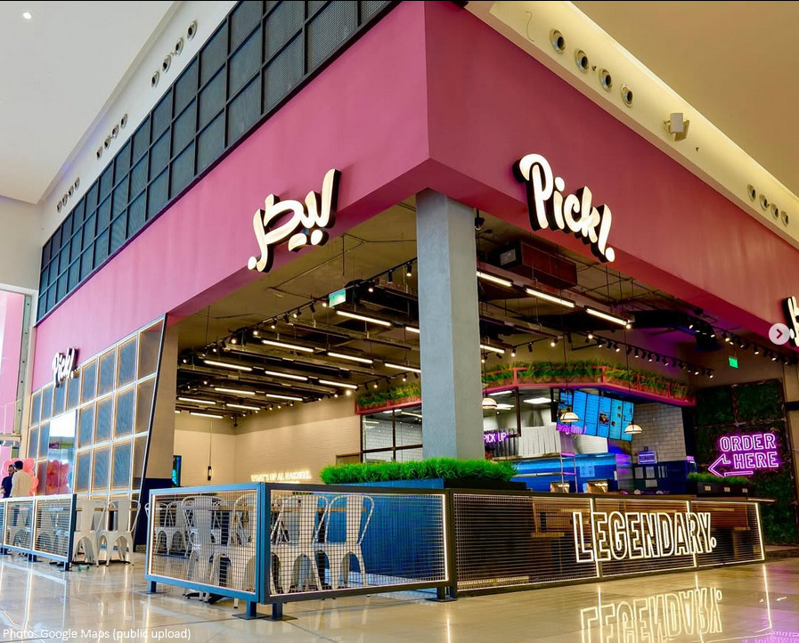Pickl fast food branch in nakheel mall, featuring bold pink branding, sleek hospitality design, and vibrant F&B atmosphere.