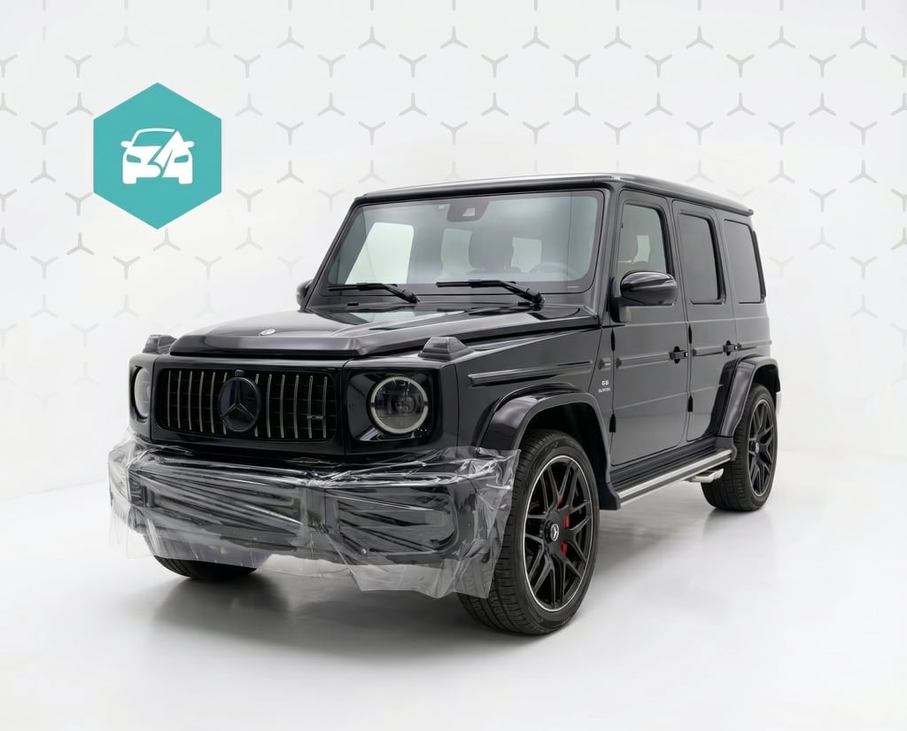 Black Mercedes-Benz G-Class SUV with paint protection film on the front bumper in a studio.