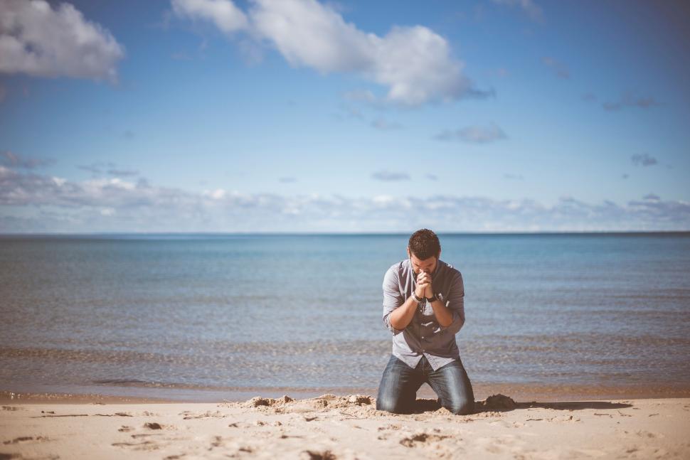 over worked man seeking help on the beach