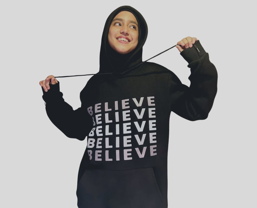 a woman in a black hoodie with a black hoodie and a black hood