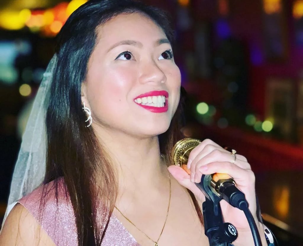 a woman in a tiaper veil and veil with a microphone