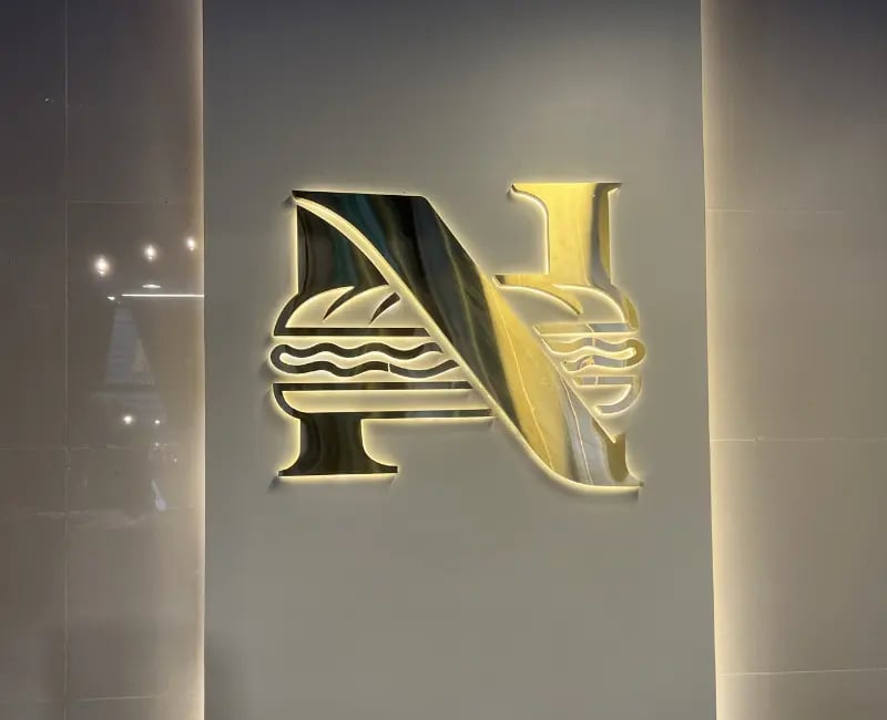 Nobar Odis Restaurant indoor counter 3D SS brushed gold backlite logo