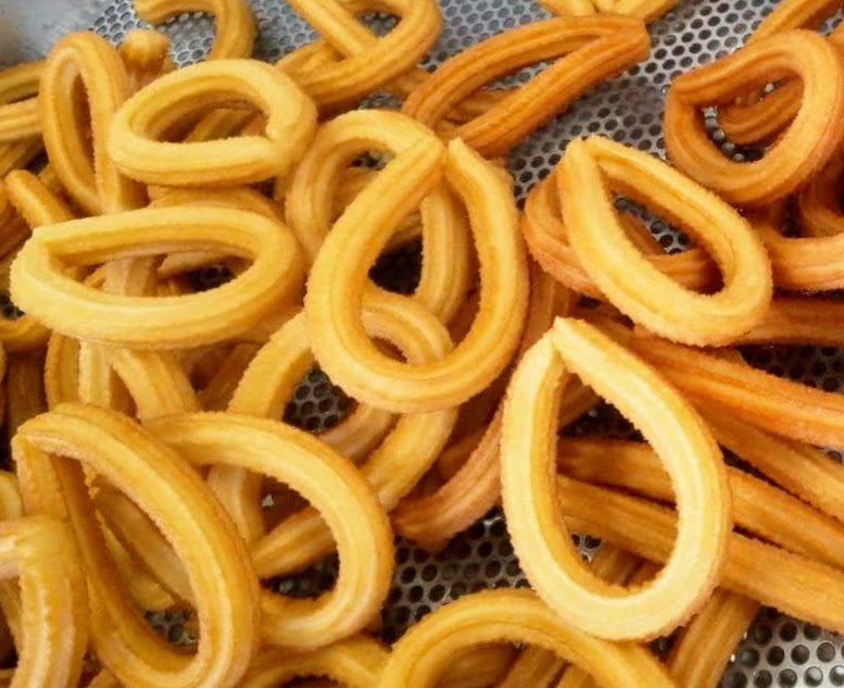 a bunch of churrons that are sitting on a metal mesh basket