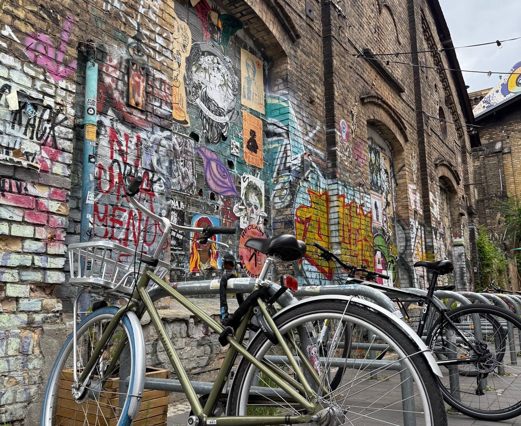 a bicycle parked next to a brick wall