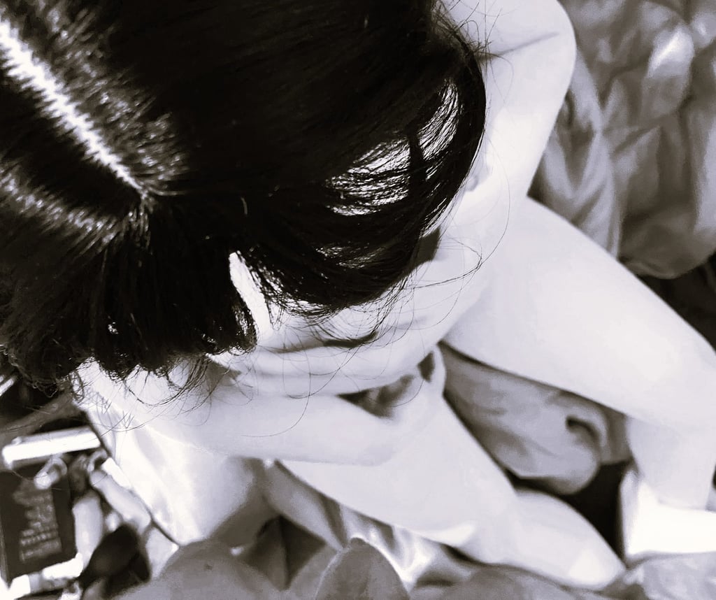 sex doll posed with breasts exposed in black and white photo