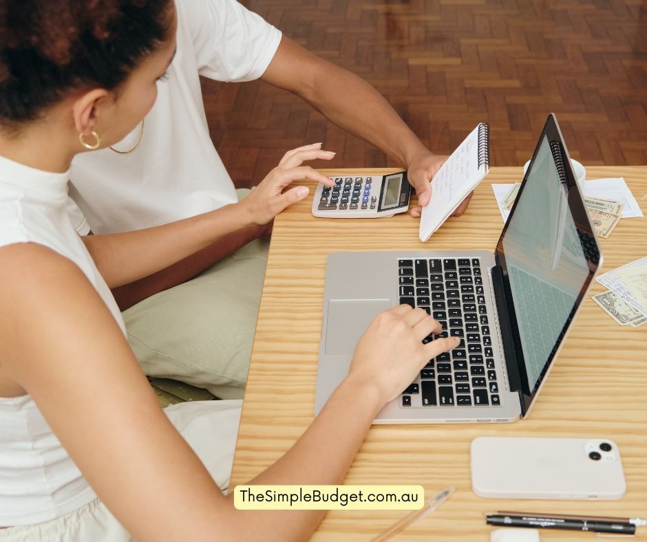 a woman sitting at a desk with a calculator