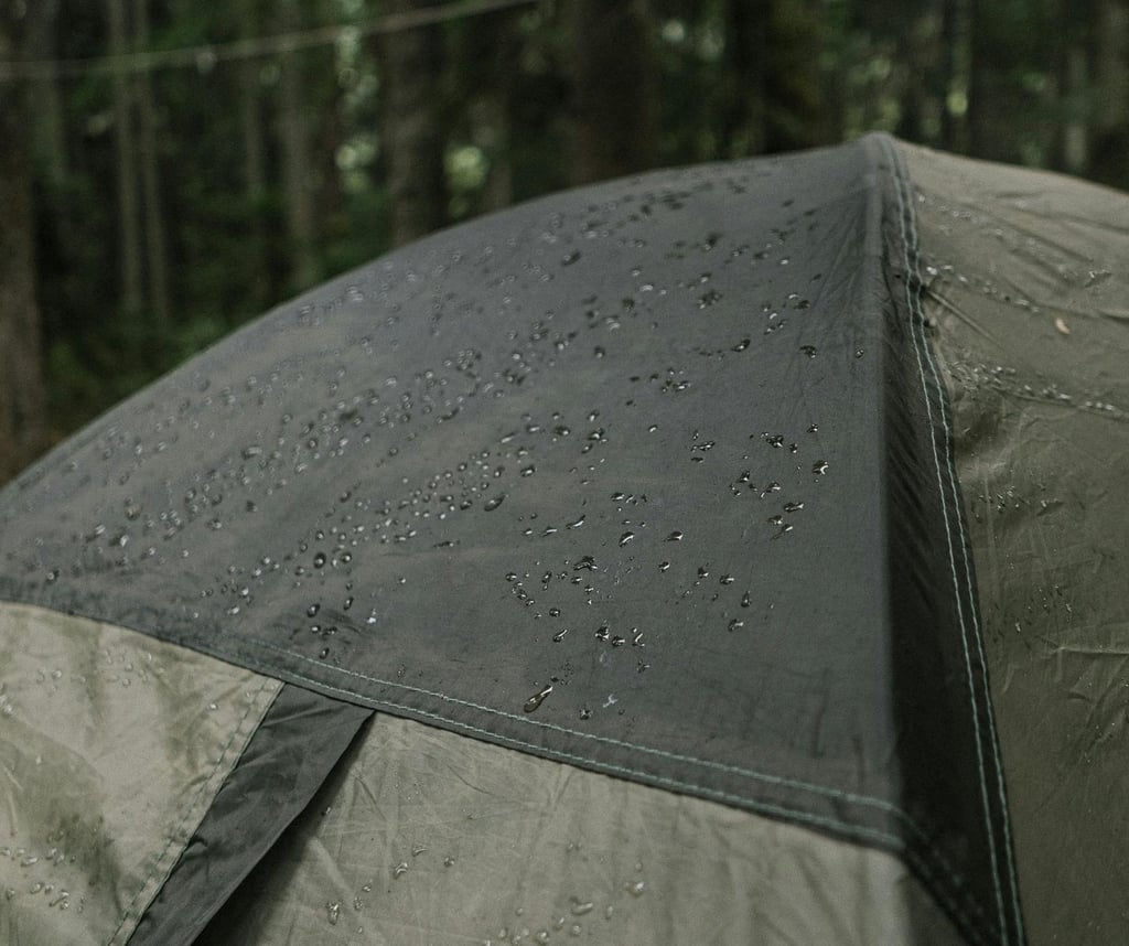 Rain on tent in forest, highlighting waterproofing, shelter durability, and survival gear use