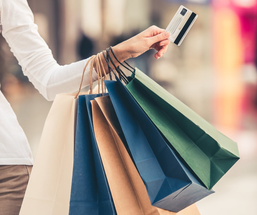 Woman with shopping bags and credit card to symbolise AI in retail