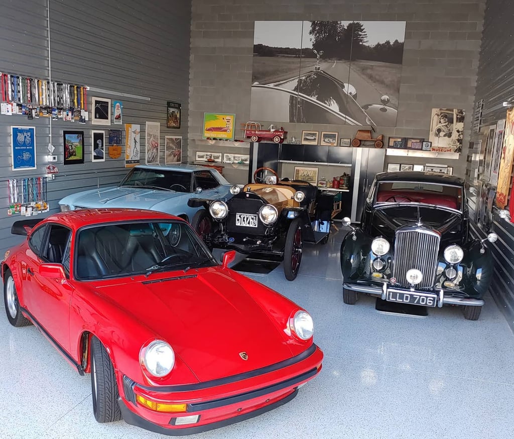 Personal car collection, stored in a warehouse, garage, or hanger.
