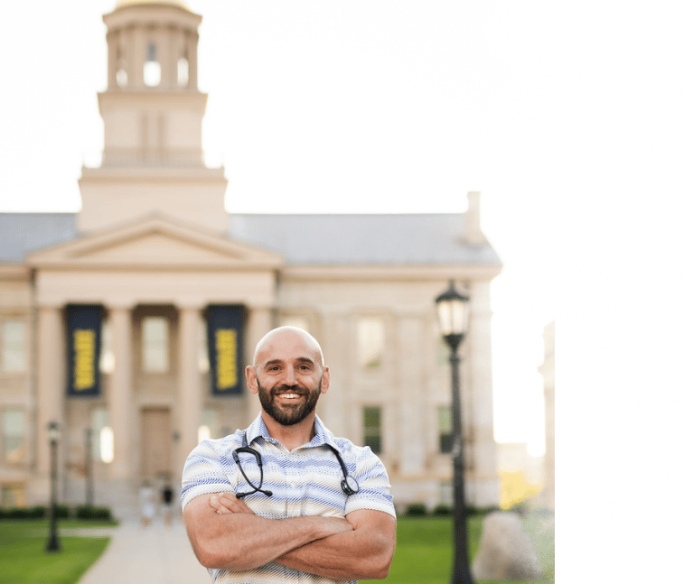 Peter Rosen, FNP with Connected Care NP standing in front of the Old Capitol building in Iowa City