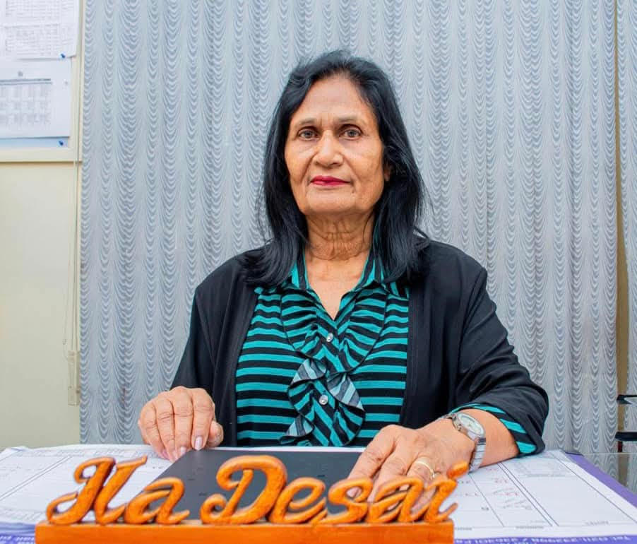 a woman sitting at a table with a sign that says he's done