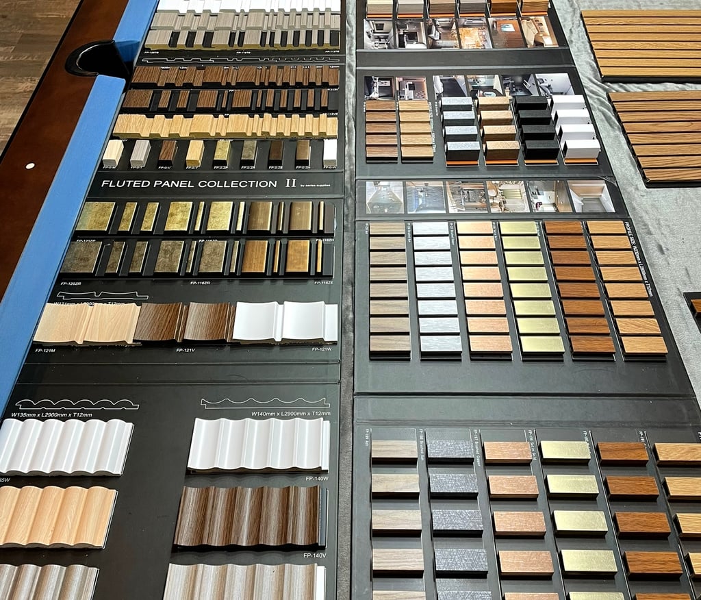 A variety of interior fluted wall panel samples in wood, metallic, solid colours for home design.