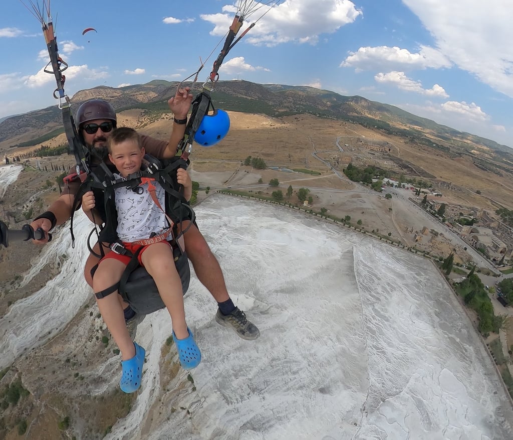paragliding child over pamukkale