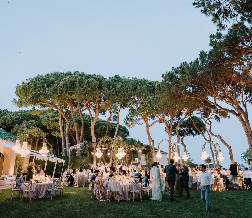 Evening wedding reception at Villa El Rincon with chandeliers and garden dining