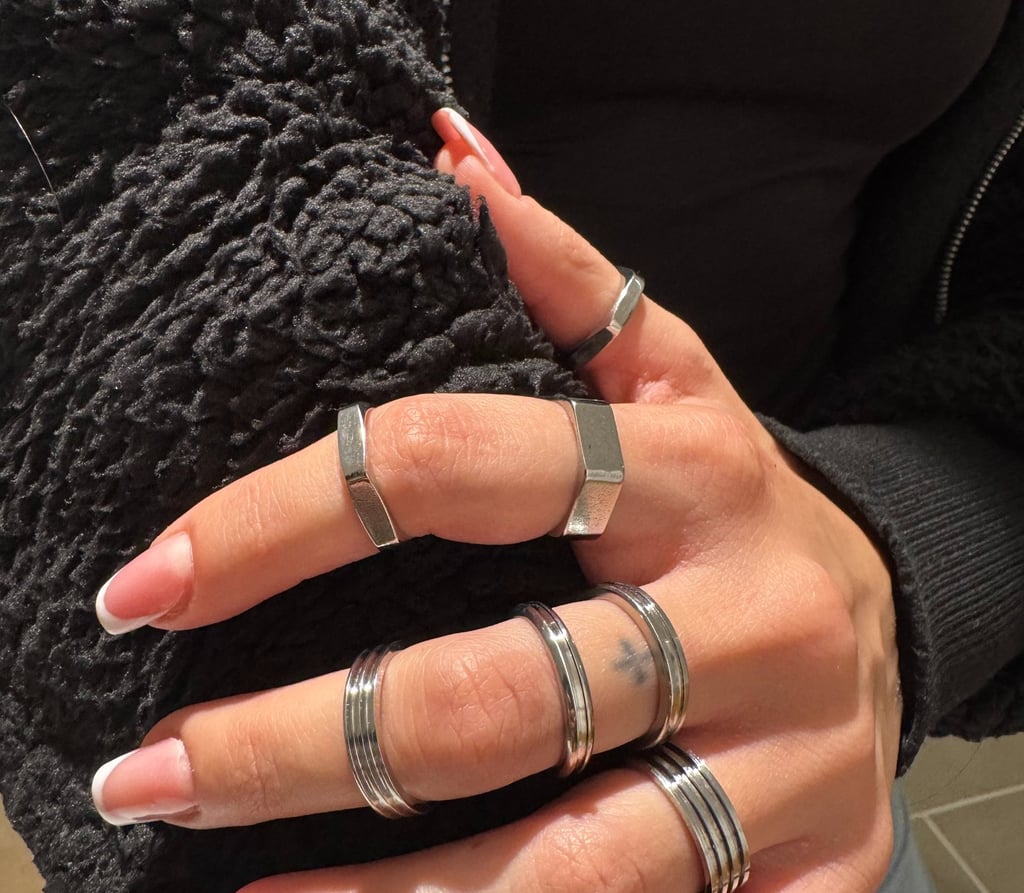 a woman's hands with rings on her fingers