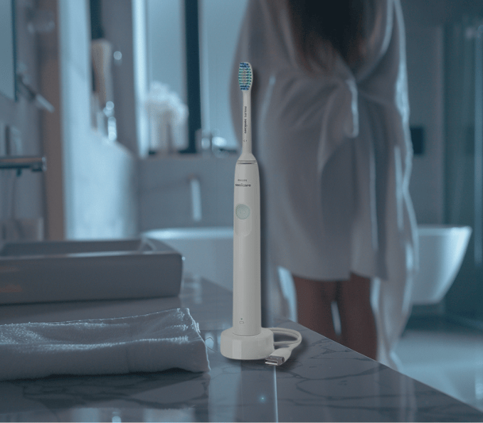 a woman in a robe is standing in front of a sink