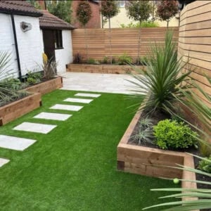 Artificial grass thriving in a shady garden where natural grass won’t grow