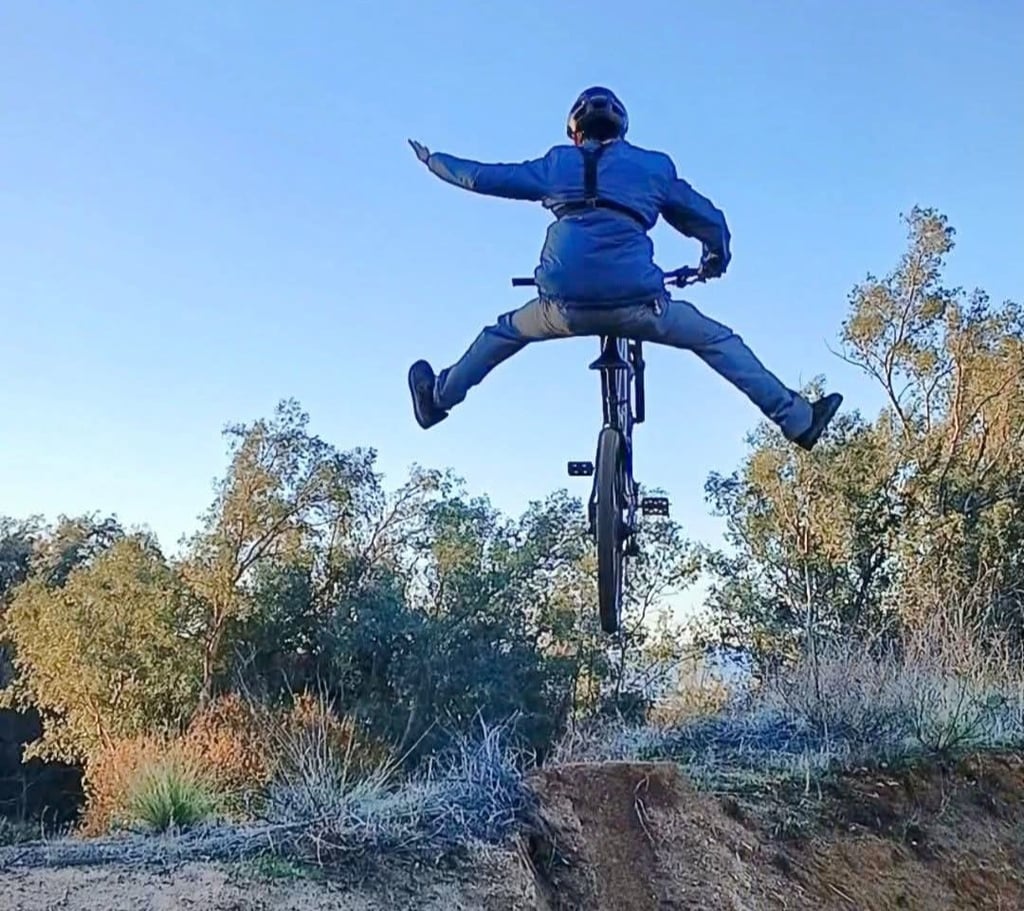 mountain biker doing a no footer one hander