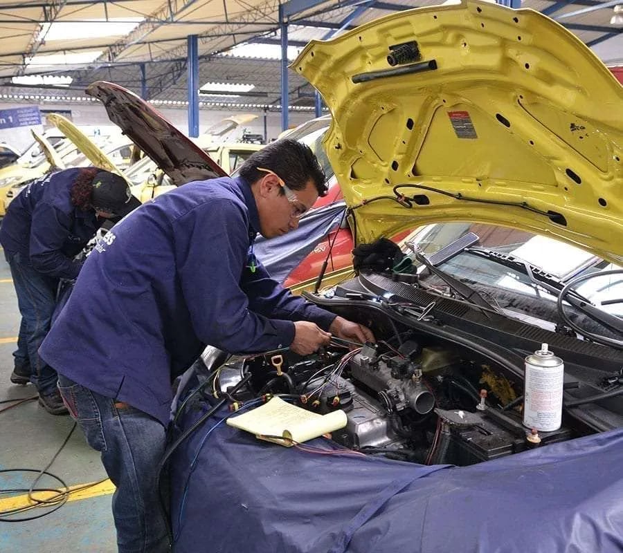a man working on a car in a garage