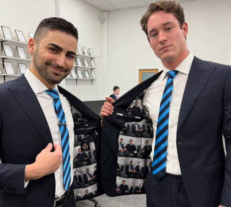 two men in suits and ties posing for a picture