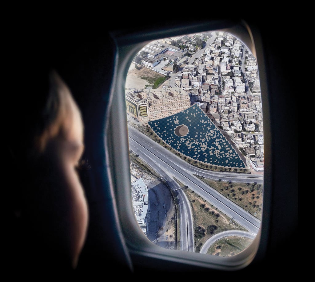 A photo of a child looking through an airplane window at a giant solar roof