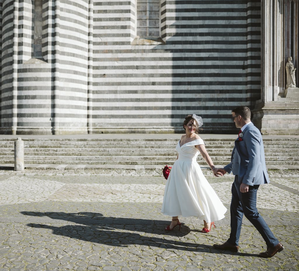 a bride and groom walking down the stairs of a church