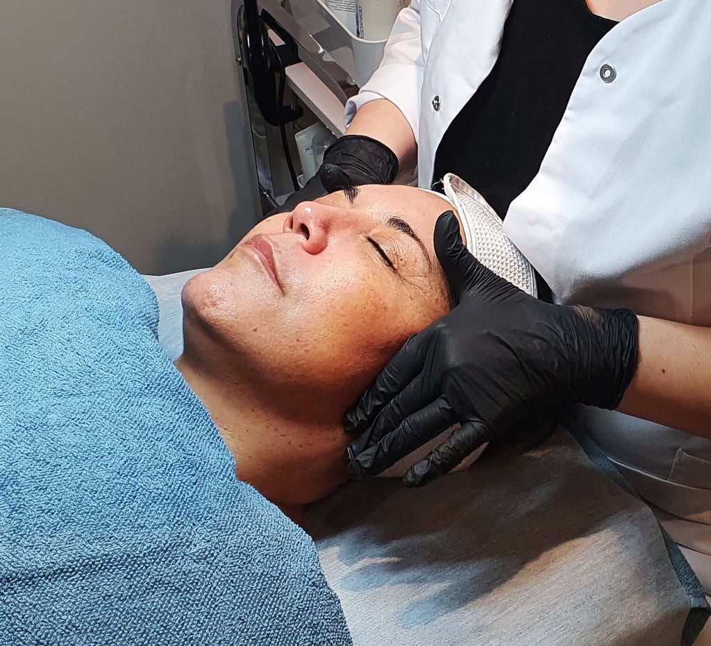 a woman getting a facial lift in a beauty salon with tprx