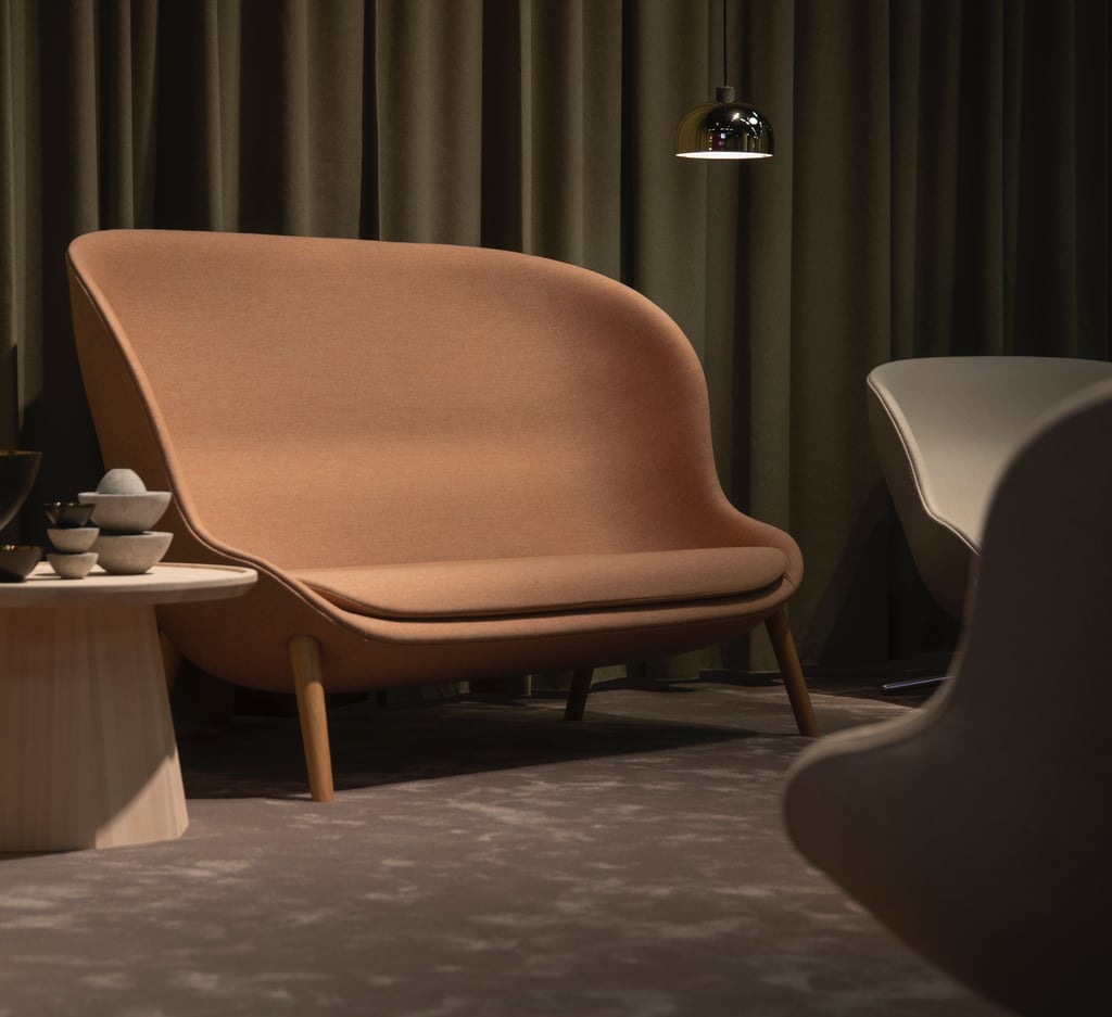 a neutral tone couch with a chair and a table with a lamp earthy tones industrial style decor stone