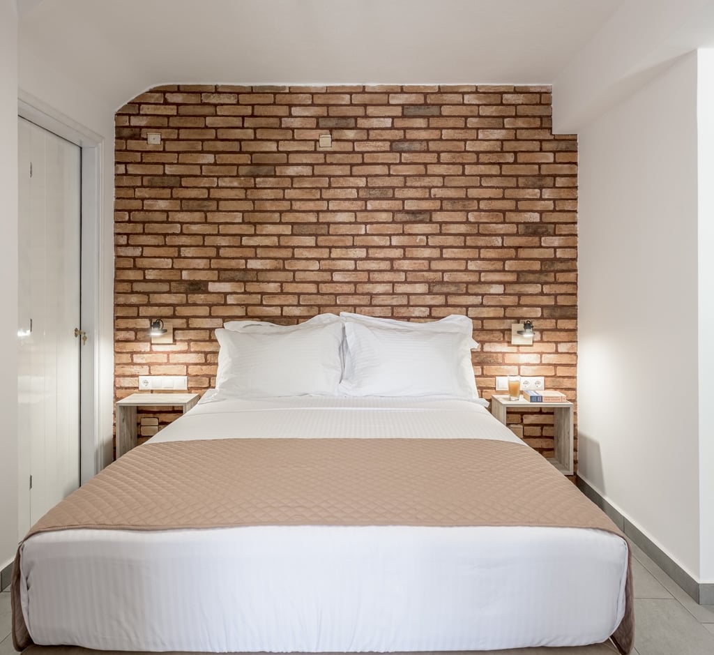 a bed with a brick wall and a brick wall