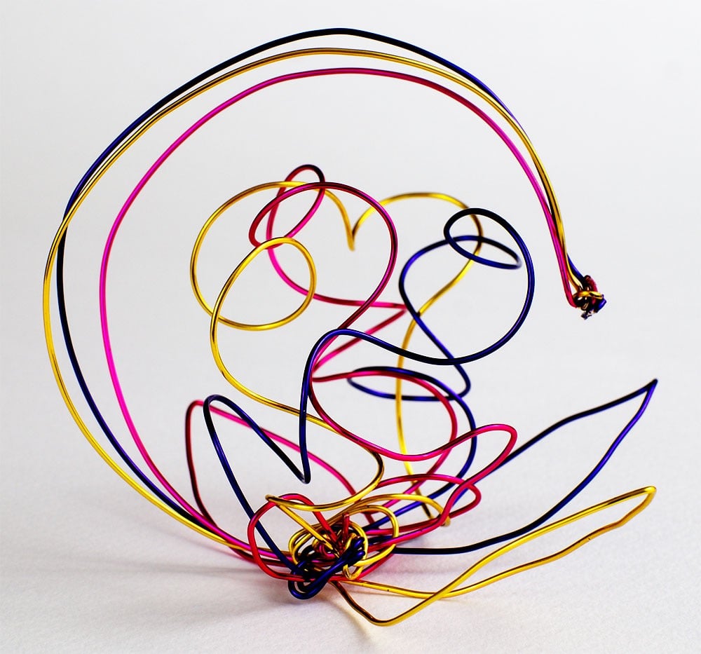 Abstract metal wire sculpture suggesting a half moon