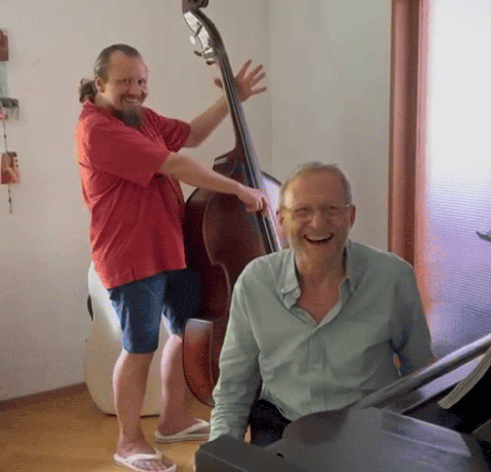 a man playing a bass and a man playing the piano