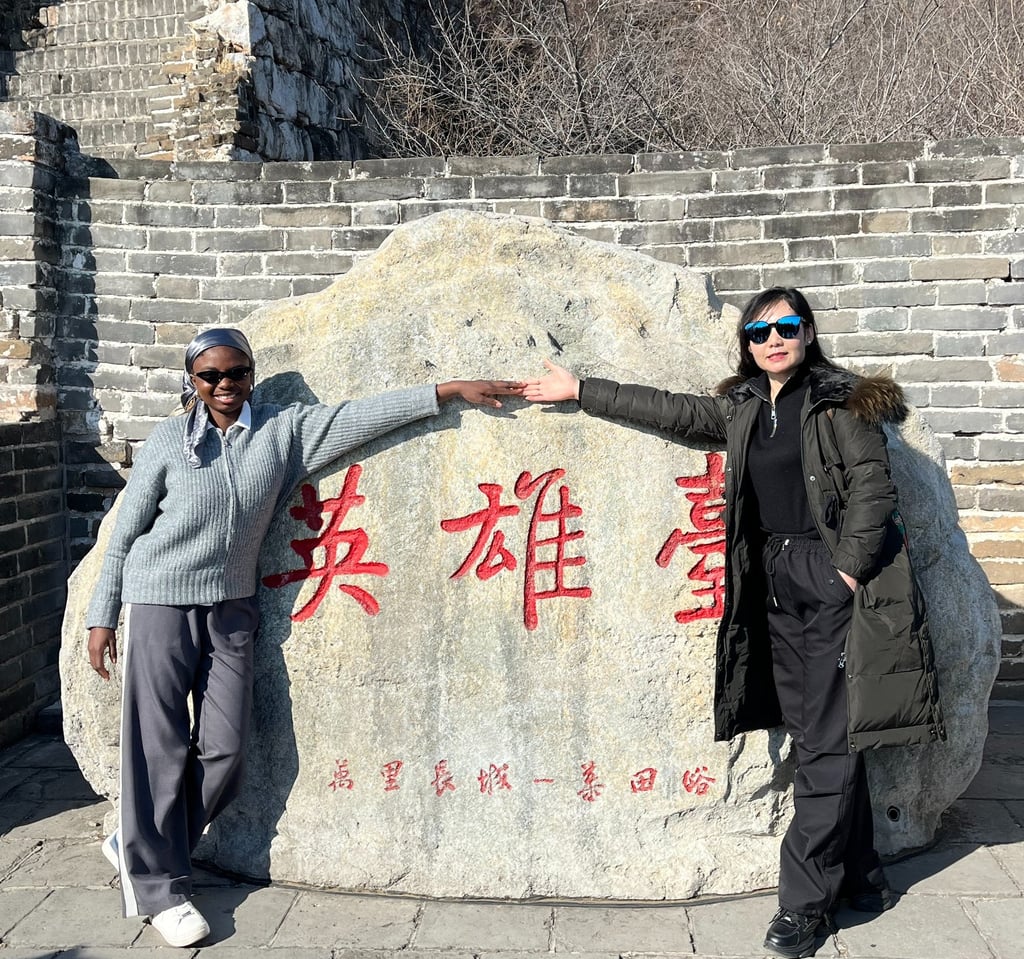 Two people holding hands at the great wall of China. Travelling for sports tourism