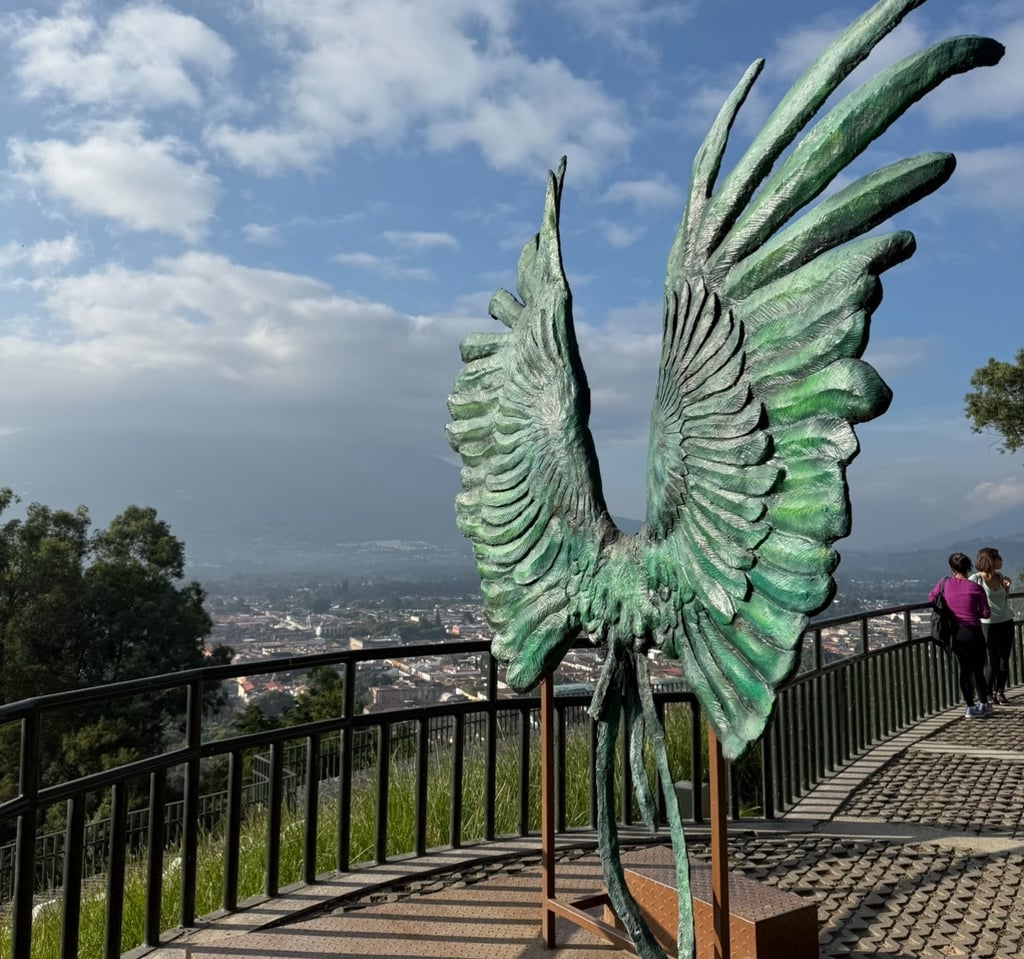 a statue of a bird with wings