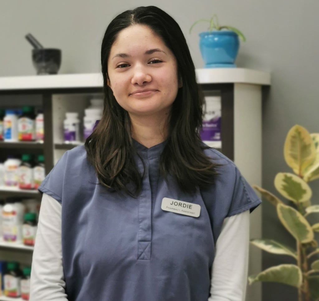 picture of woman with dark hair wearing blue scrubs