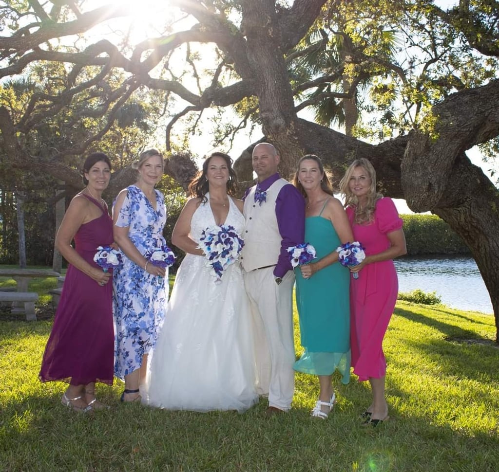 a bride and groomsmid posing for a photo